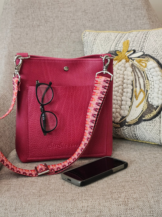Fuchsia crossbody bag with bright red and pink webbing strap and bright nickel hardward